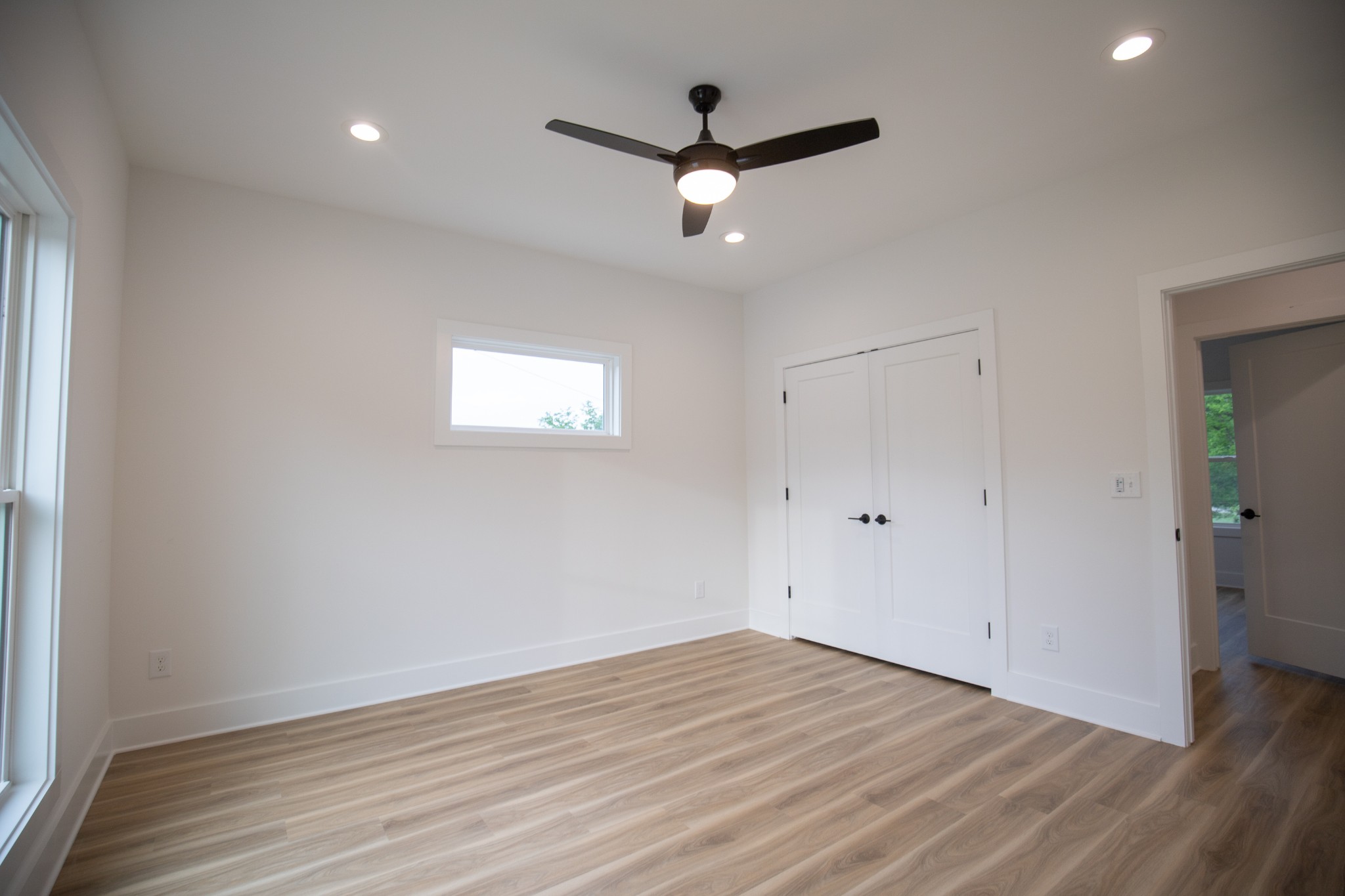 308 Larkin Springs Road Madison, TN 37115 - Photo 22 of 25 an empty room with wooden floor and a ceiling fan