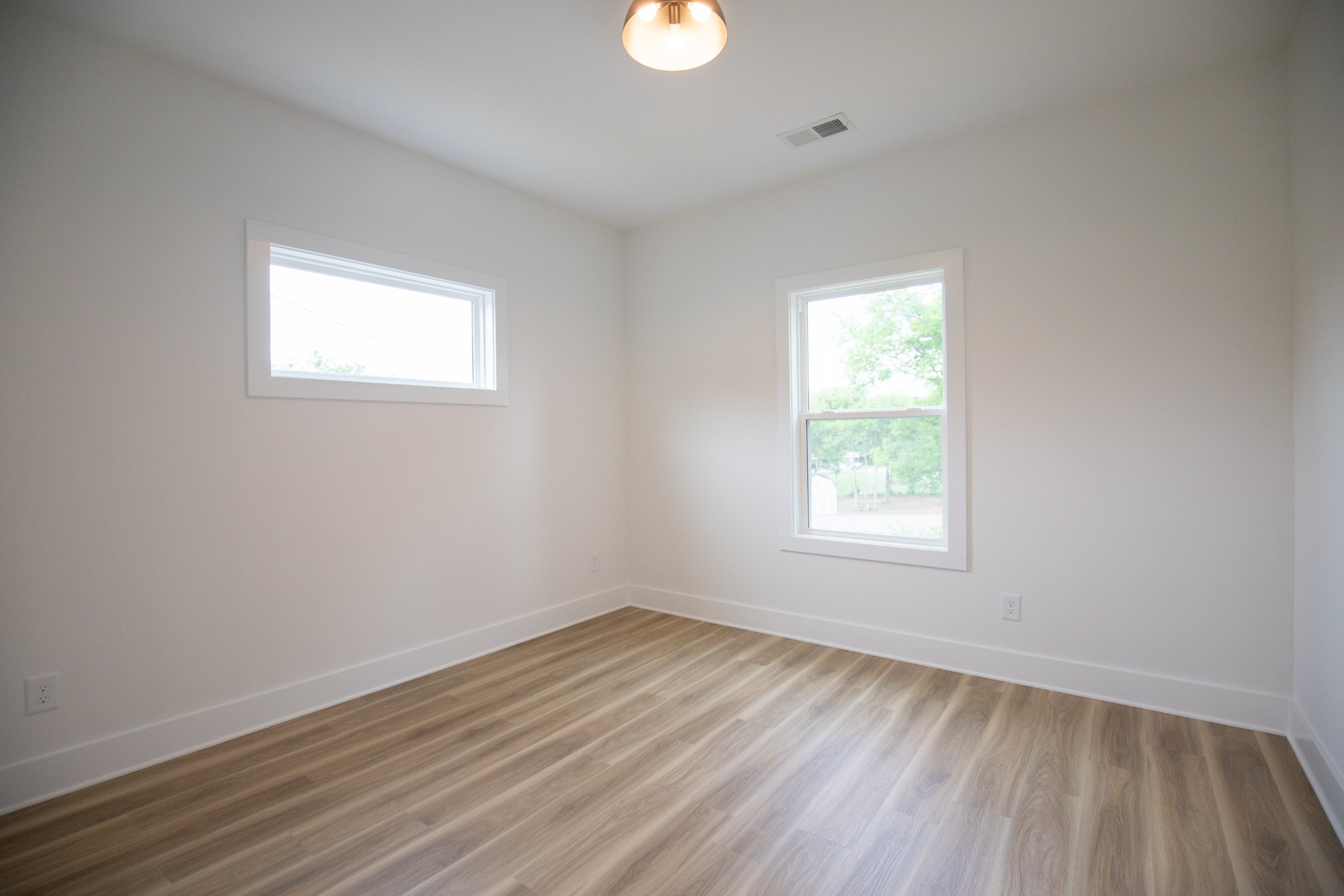 308 Larkin Springs Road Madison, TN 37115 - Photo 23 of 25 an empty room with wooden floor and windows