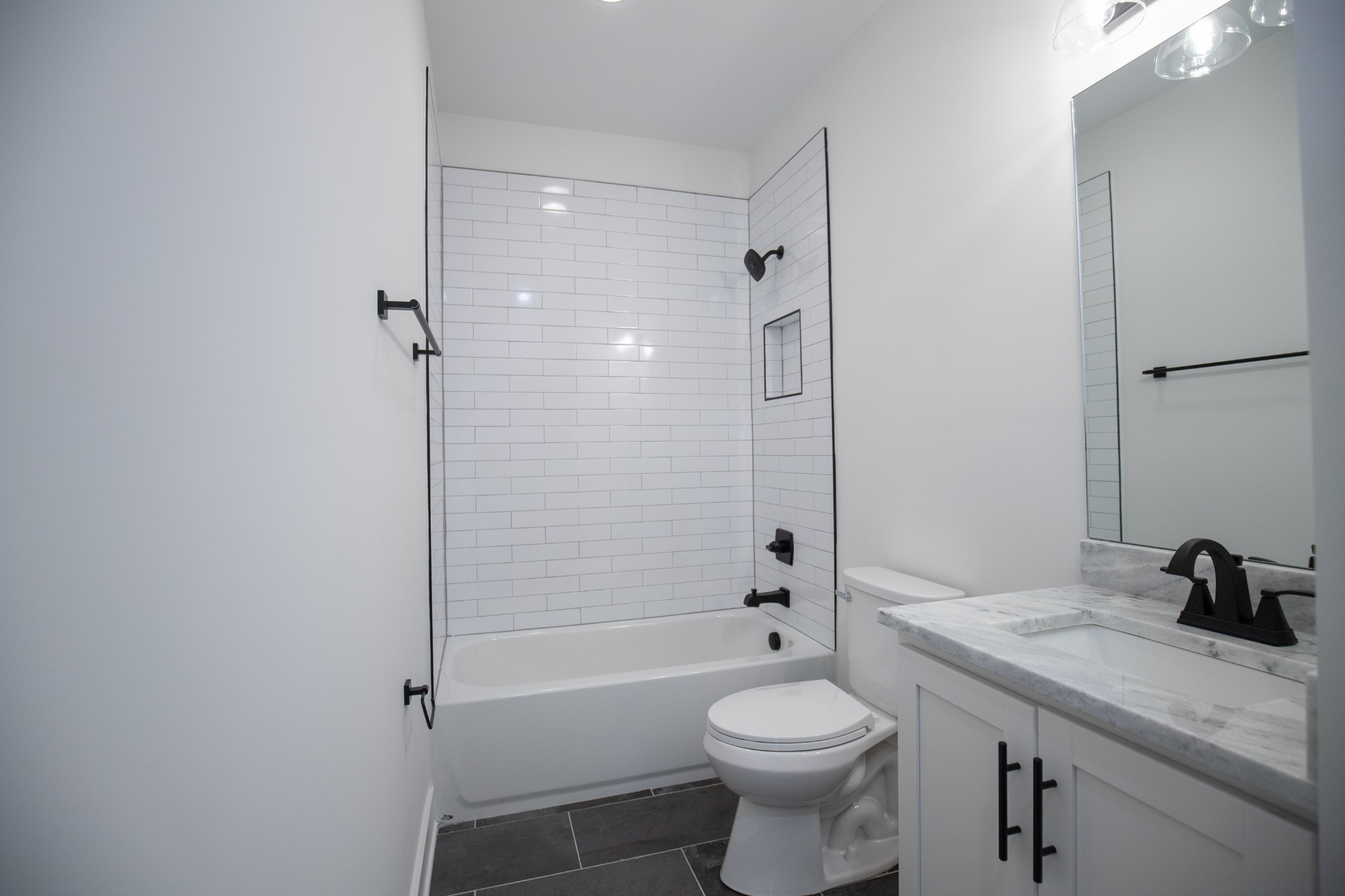 308 Larkin Springs Road Madison, TN 37115 - Photo 24 of 25 a bathroom with a granite countertop toilet a sink and a bathtub