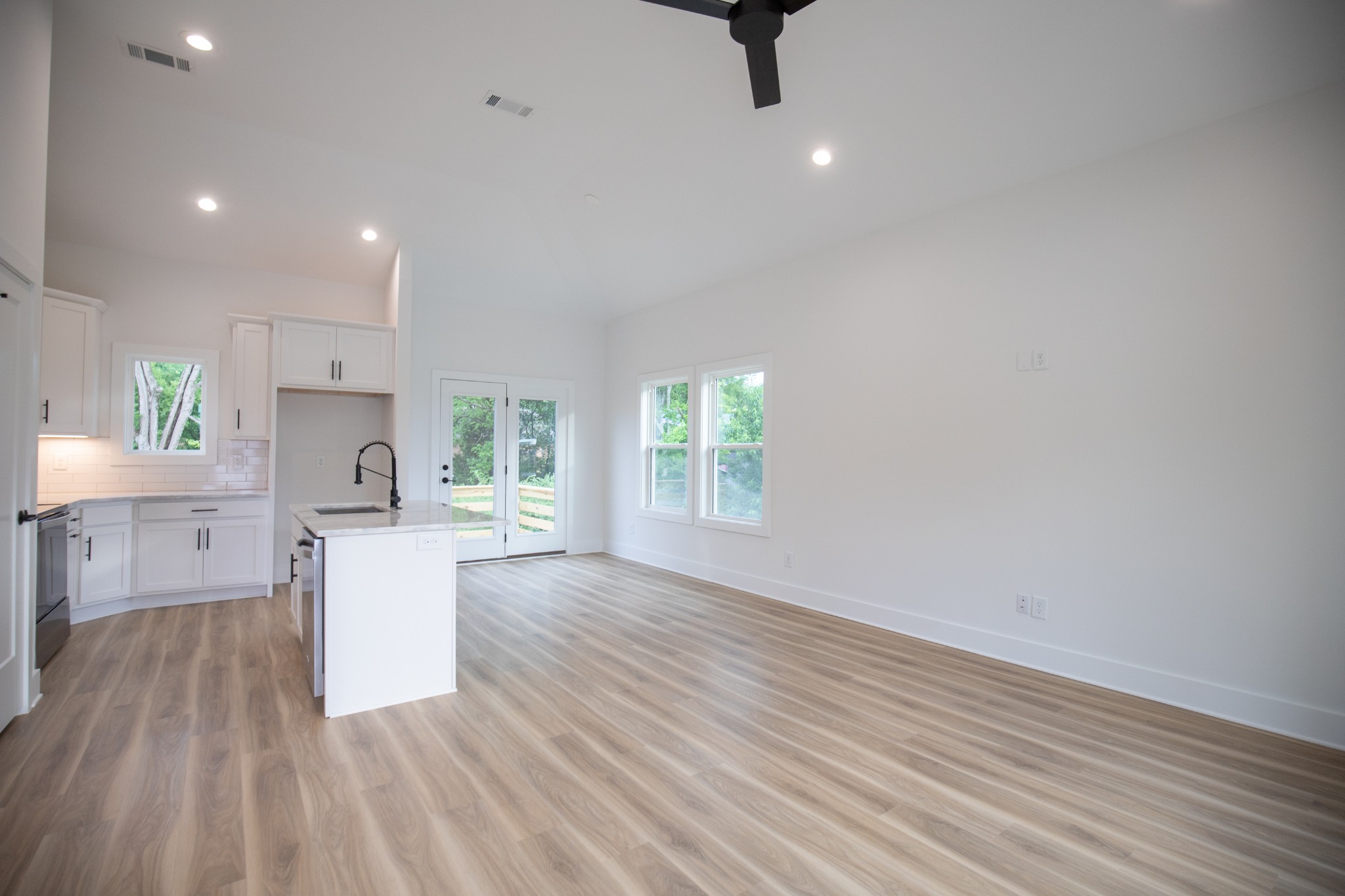 308 Larkin Springs Road Madison, TN 37115 - Photo 6 of 25 a open kitchen with white cabinets and wooden floor