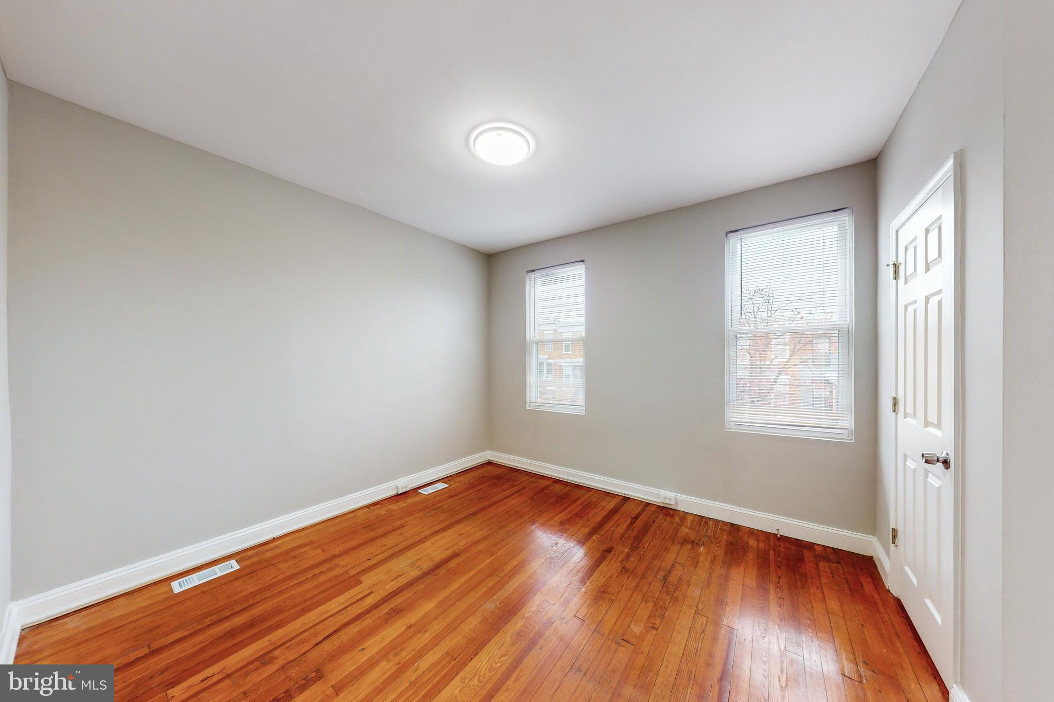 2867 Mayfield Avenue Baltimore, MD 21213 - Photo 17 of 25 a view of empty room with wooden floor and fan