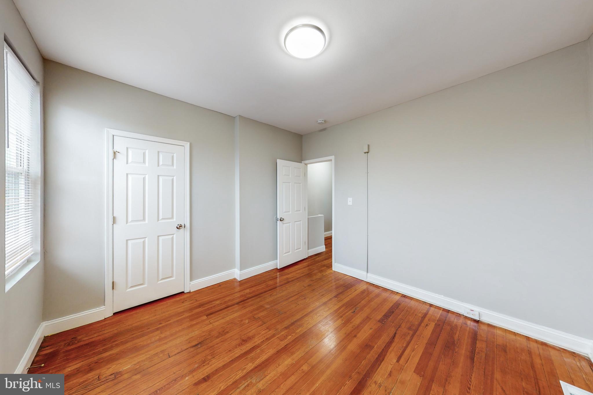 2867 Mayfield Avenue Baltimore, MD 21213 - Photo 18 of 25 a view of empty room with wooden floor