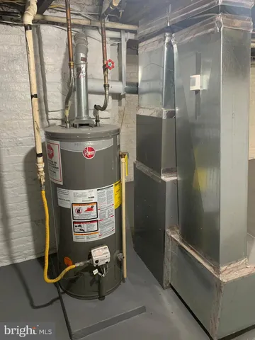 a room with water heater and a refrigerator