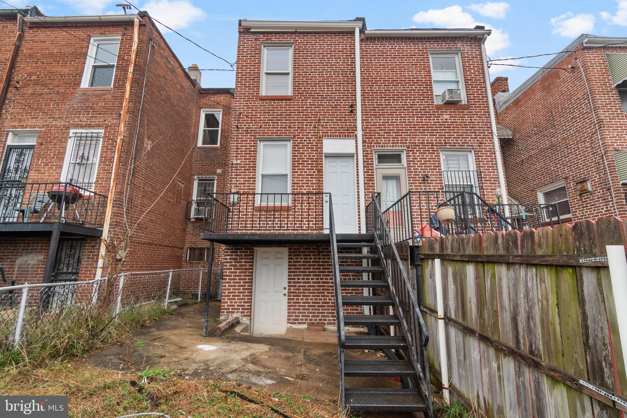 2867 Mayfield Avenue Baltimore, MD 21213 - Photo 22 of 25 a view of a brick house with many windows