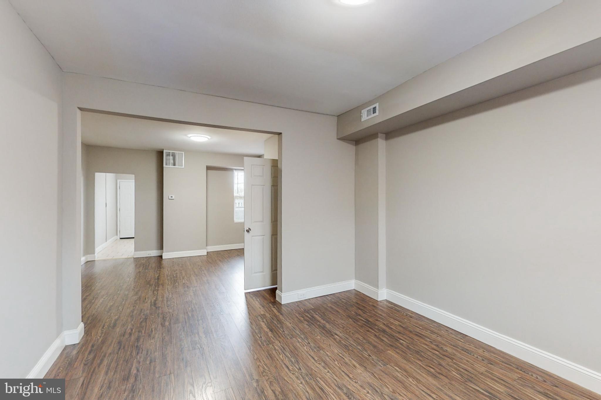 2867 Mayfield Avenue Baltimore, MD 21213 - Photo 4 of 25 a view of an empty room with wooden floor
