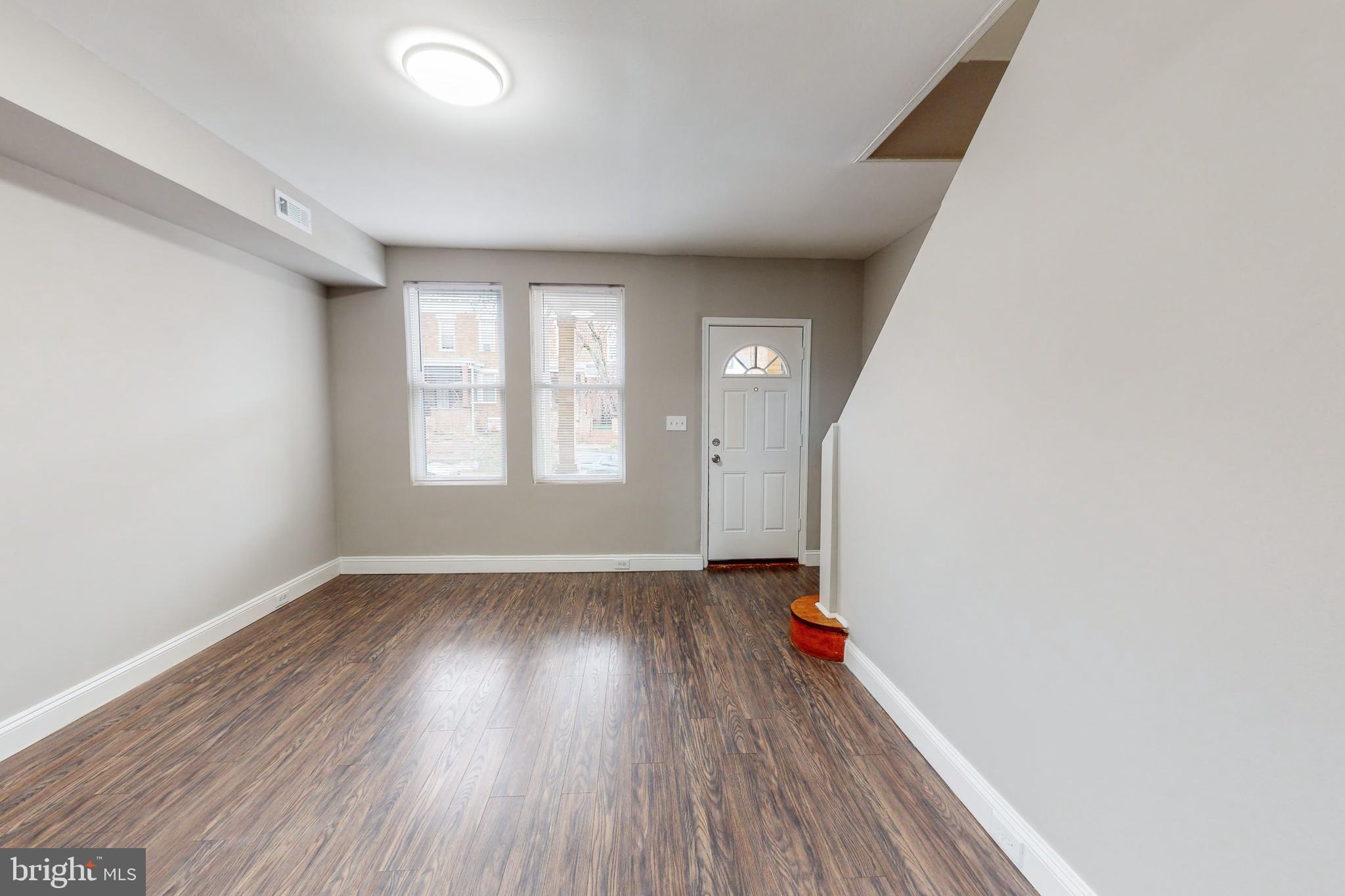 2867 Mayfield Avenue Baltimore, MD 21213 - Photo 7 of 25 an empty room with wooden floor and windows