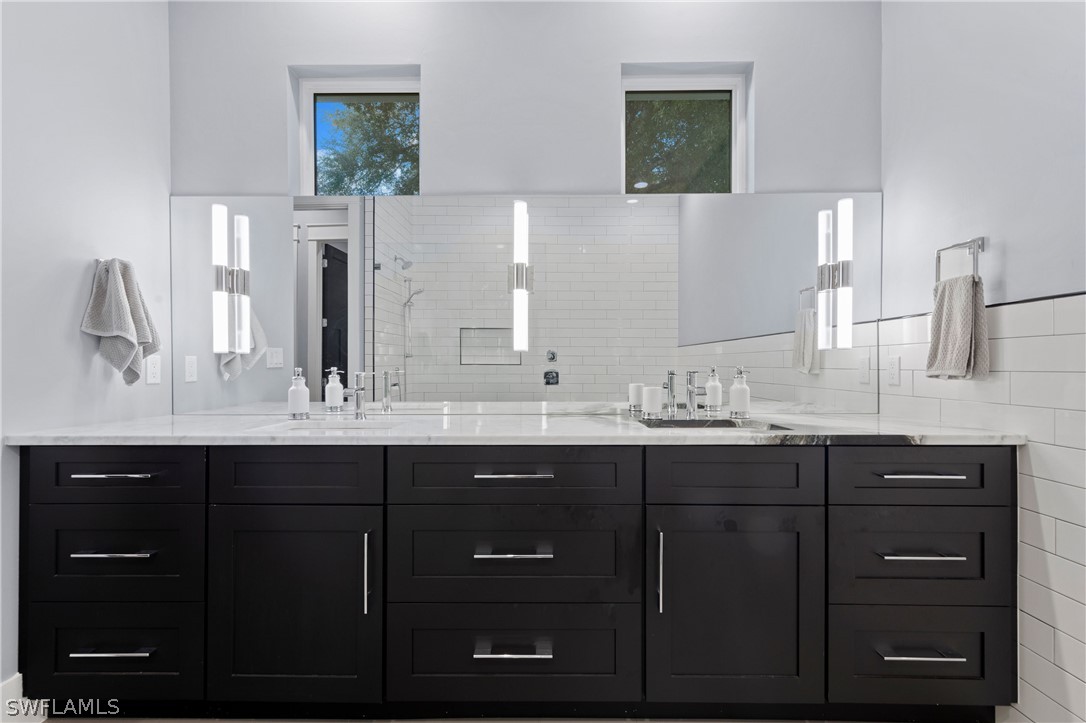 1606 Ardmore Road Fort Myers, FL 33901 - Photo 22 of 33 a bathroom with a double vanity sink and a mirror