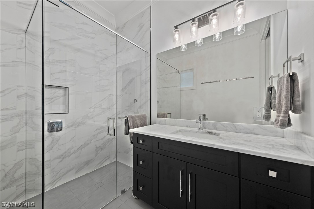 1606 Ardmore Road Fort Myers, FL 33901 - Photo 25 of 33 a bathroom with a double vanity sink mirror and shower