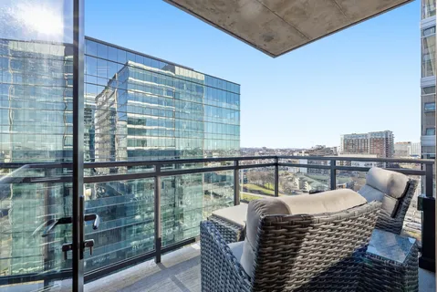 a balcony with furniture and a potted plant