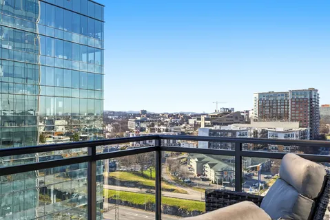 a view of a balcony with a floor to ceiling window next to a building