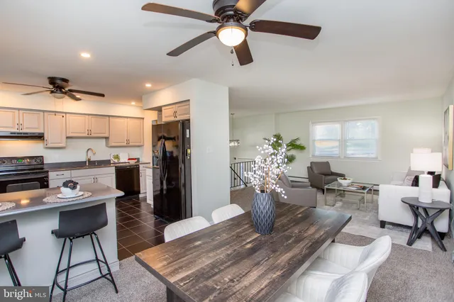 a kitchen with granite countertop white cabinets and appliances