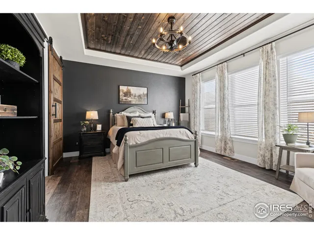 a bedroom with a large bed and a tv