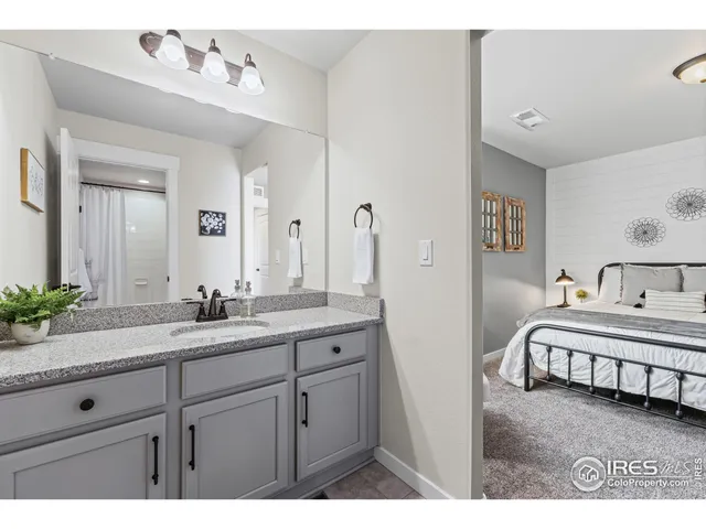 a spacious bathroom with a double vanity sink and a mirror