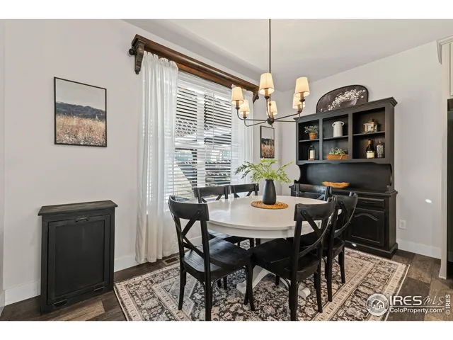 a view of a dining room with furniture and chandelier