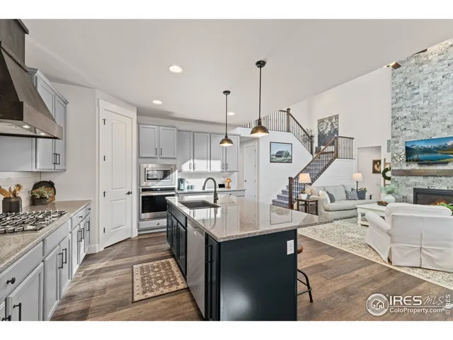 a kitchen with stainless steel appliances kitchen island granite countertop a sink and cabinets