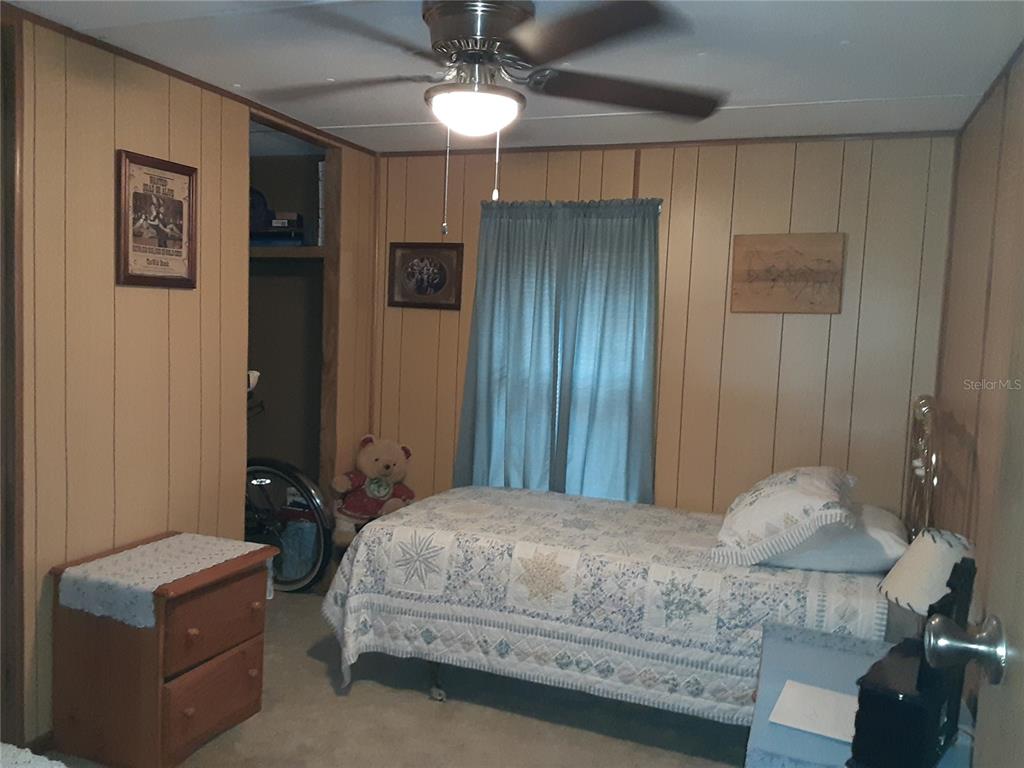 8333 Kathleen Road Lakeland, FL 33810 - Photo 12 of 24 a bedroom with a bed and a chandelier