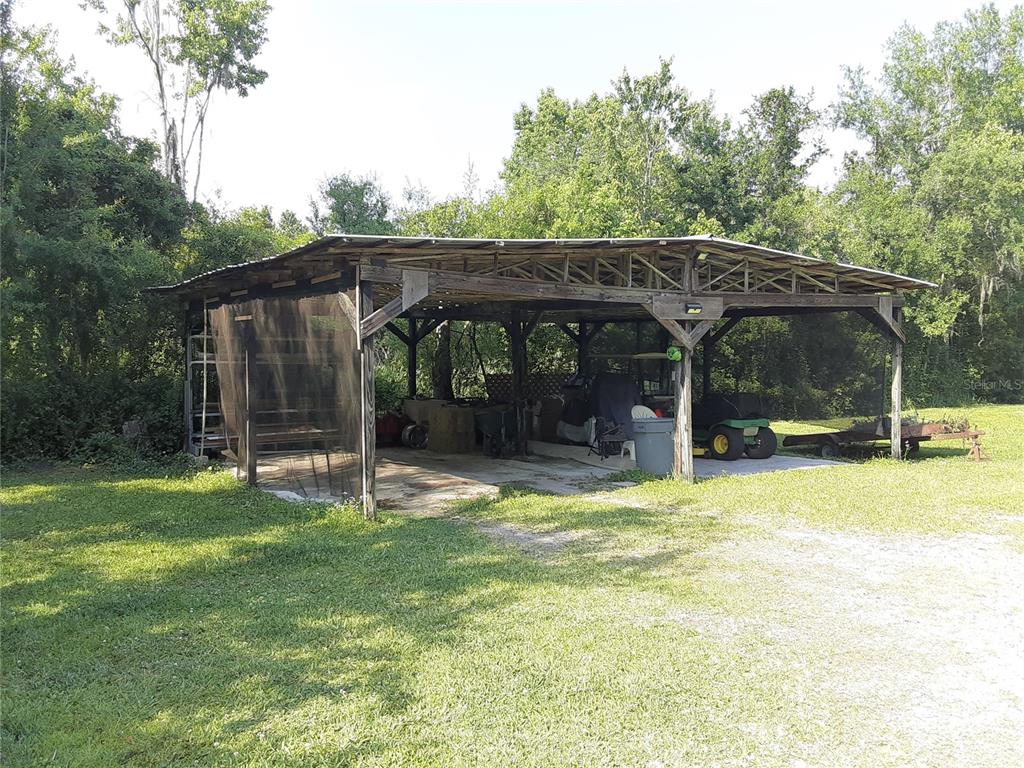 8333 Kathleen Road Lakeland, FL 33810 - Photo 5 of 24 a view of a patio with a table and chairs under an umbrella
