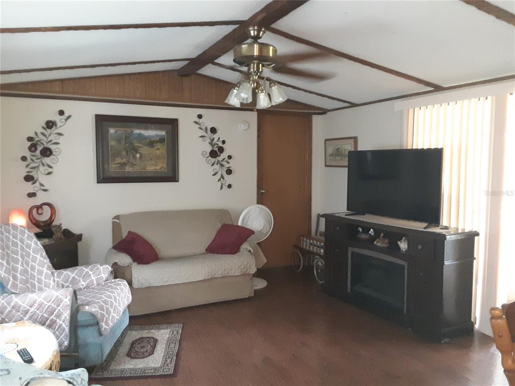 8333 Kathleen Road Lakeland, FL 33810 - Photo 7 of 24 a living room with furniture and a flat screen tv