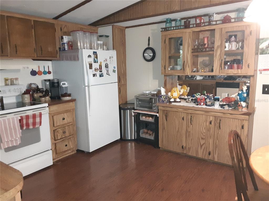 8333 Kathleen Road Lakeland, FL 33810 - Photo 8 of 24 a kitchen with stainless steel appliances a refrigerator and a stove top oven