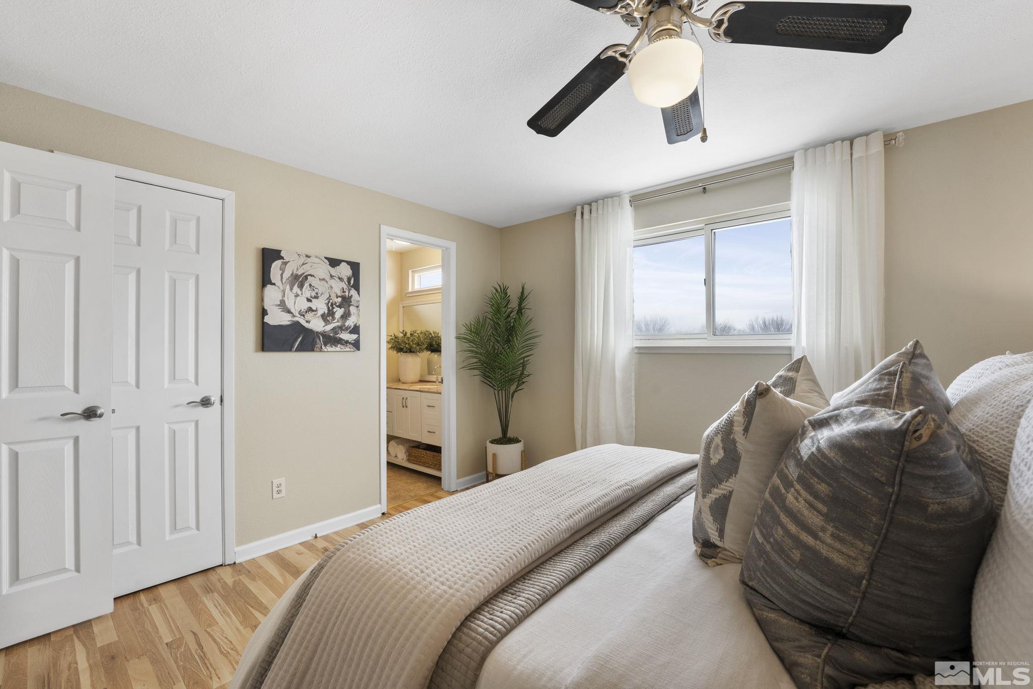 14070 Tourmaline Drive Reno, NV 89521 - Photo 18 of 39 a bedroom with a bed and a chandelier
