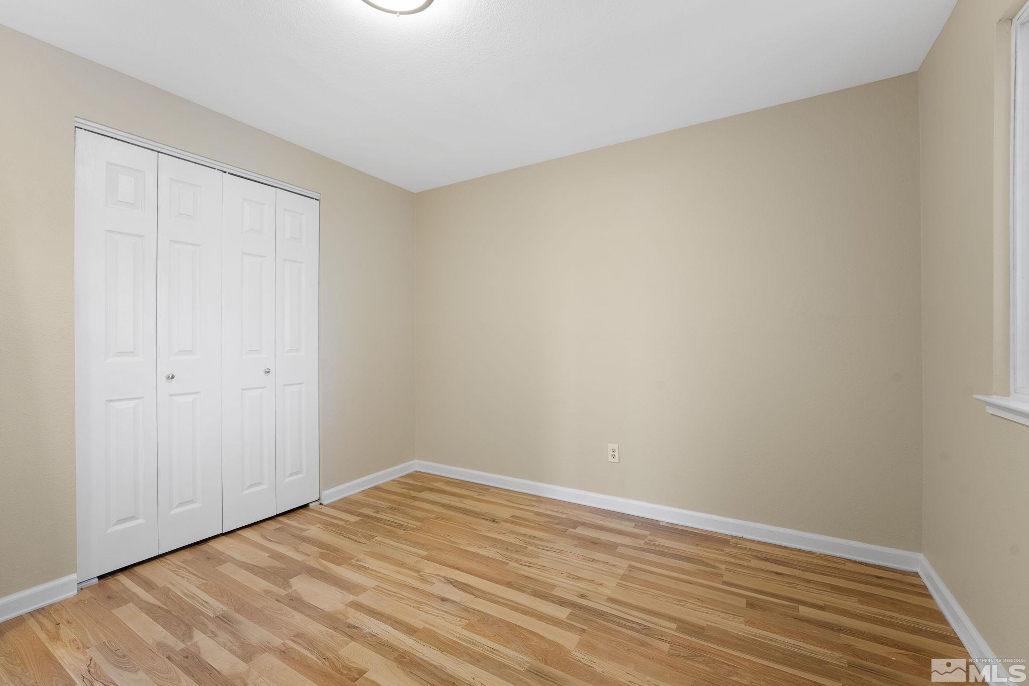 14070 Tourmaline Drive Reno, NV 89521 - Photo 23 of 39 a view of empty room with wooden floor