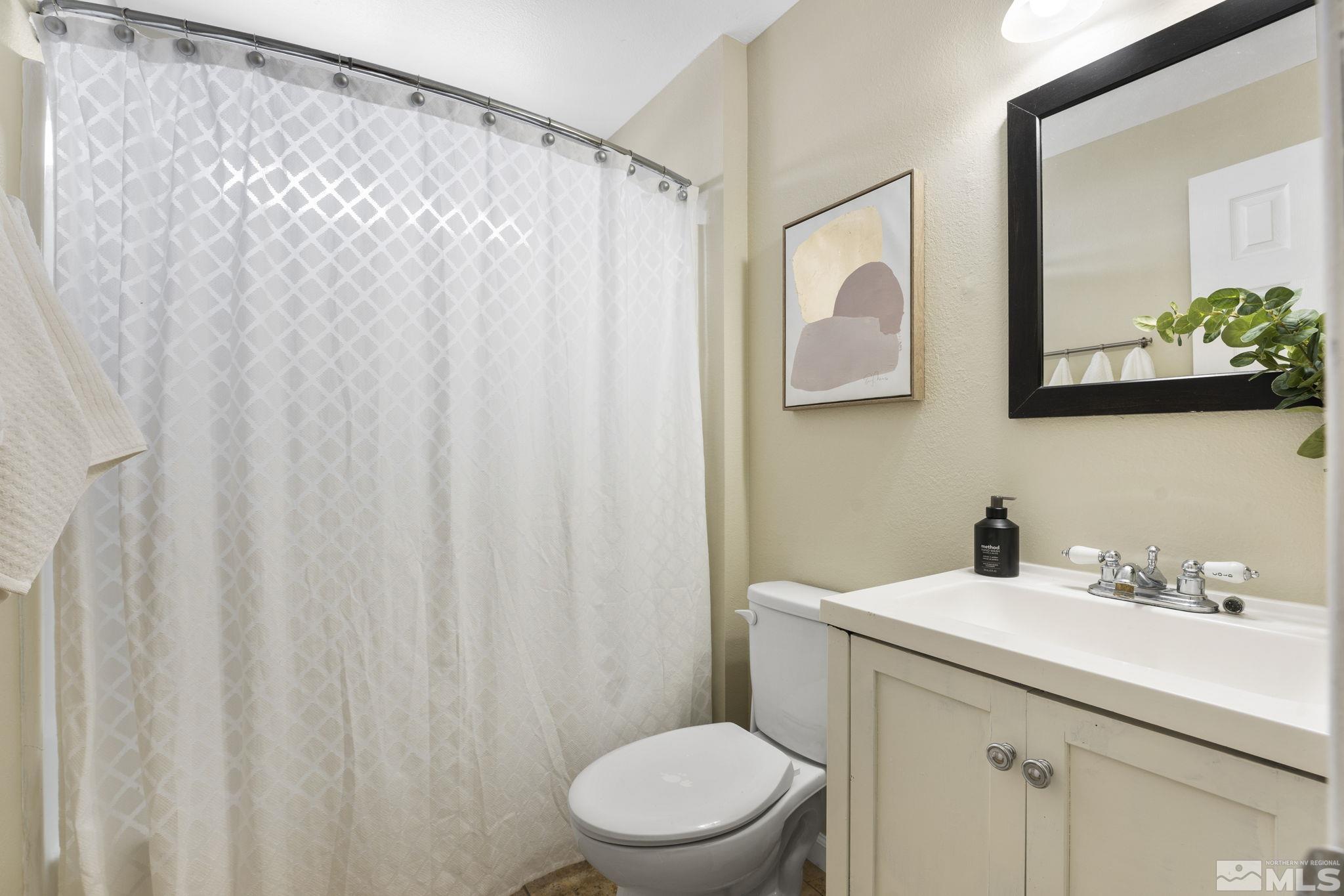 14070 Tourmaline Drive Reno, NV 89521 - Photo 24 of 39 a bathroom with a sink mirror vanity and toilet