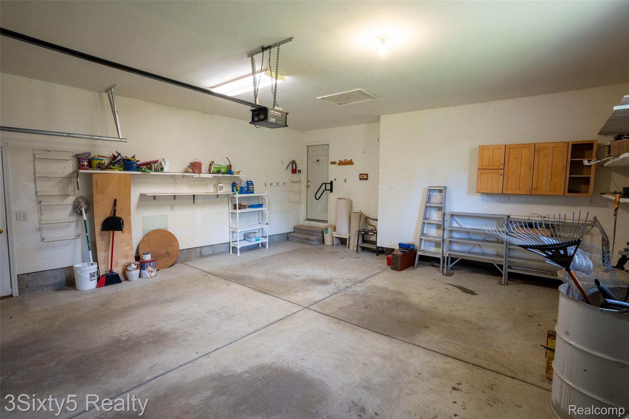 1783 Farnsworth Road Lapeer, MI 48446 - Photo 39 of 51 Garage featuring a garage door opener
