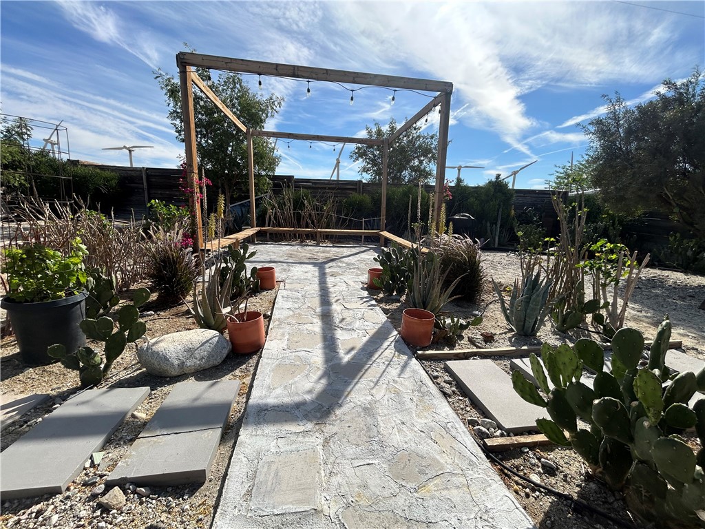 19790 Cooper Road Palm Springs, CA 92262 - Photo 21 of 22 a view of a patio with table and chairs potted plants with sky view