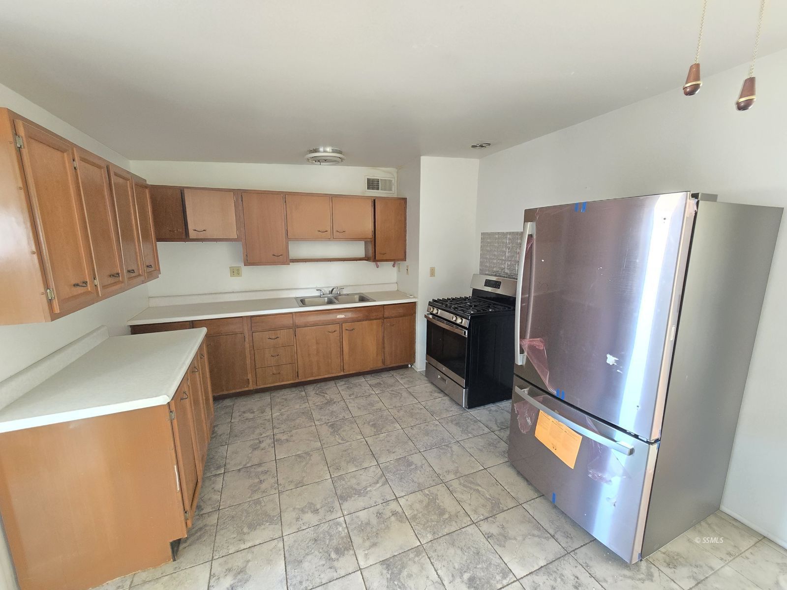 633 South Allen Street Ridgecrest, CA 93555 - Photo 4 of 21 a kitchen with stainless steel appliances granite countertop a refrigerator a stove a sink and a refrigerator