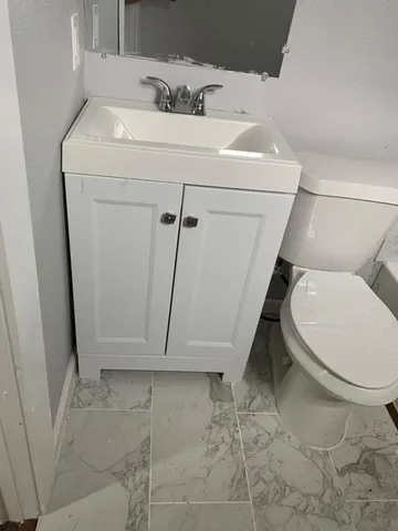 a bathroom with a sink toilet and tub