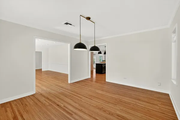 an empty room with windows and fireplace