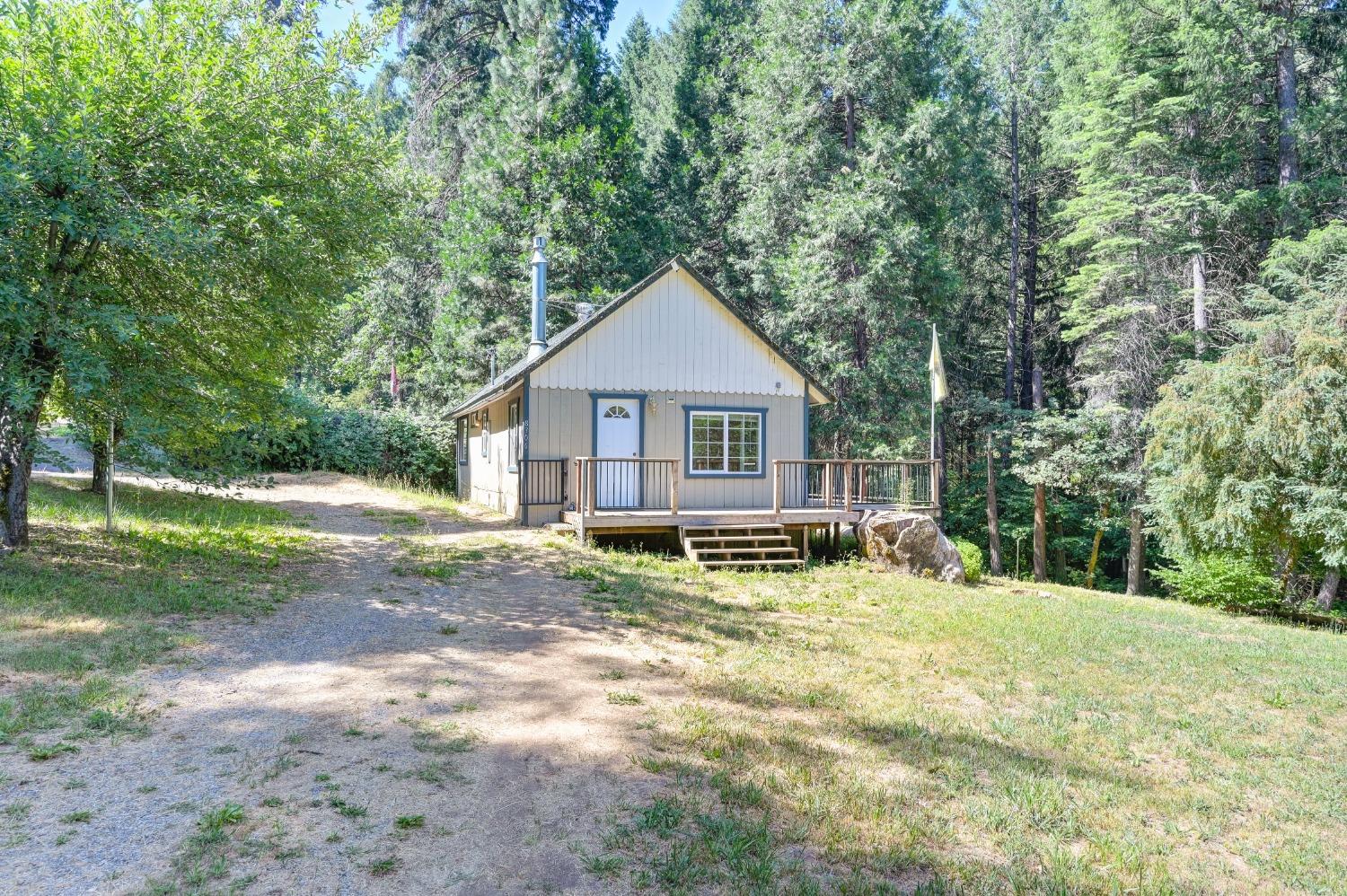 a backyard of a house with yard and outdoor seating