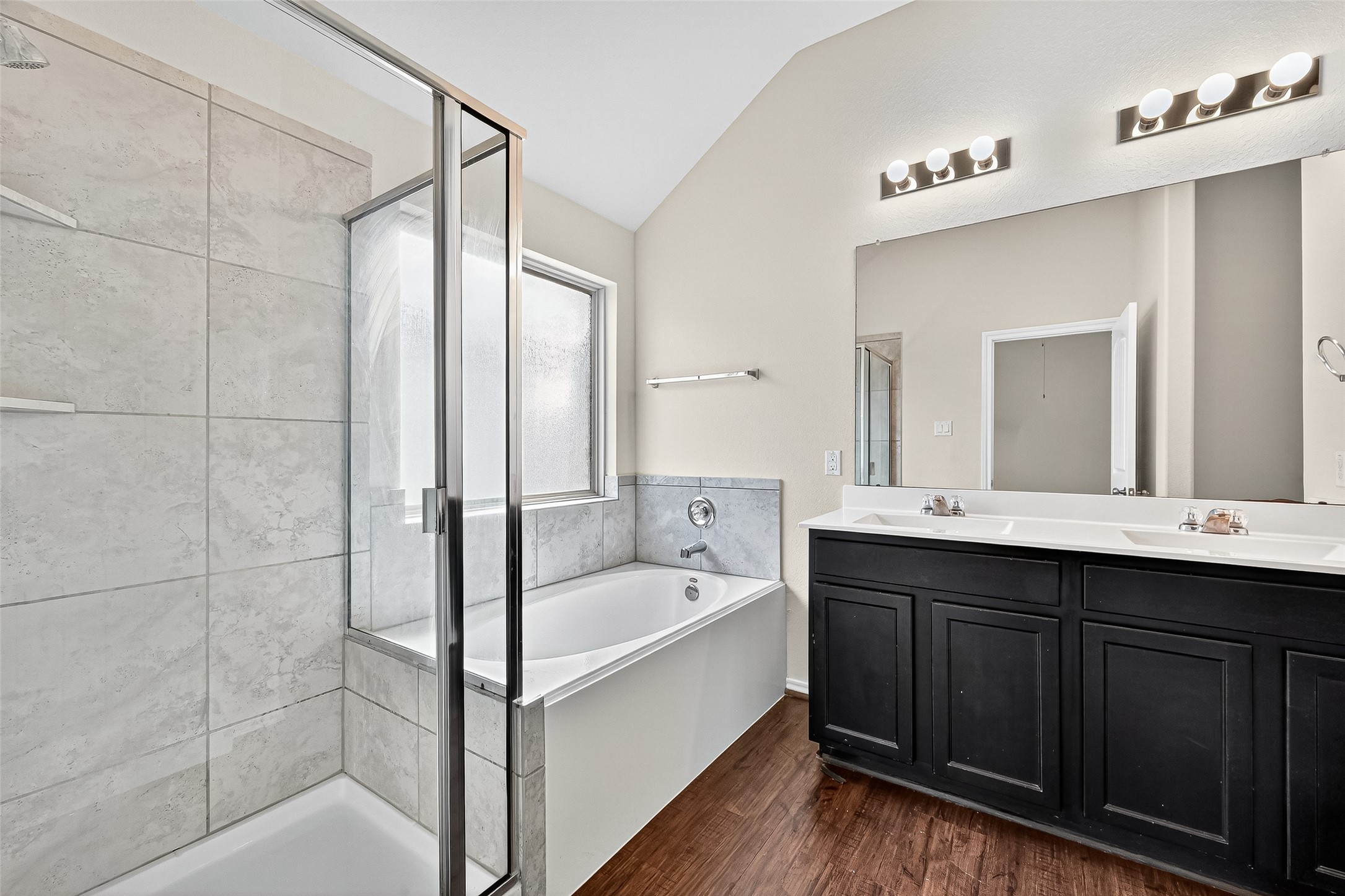 5603 Savanna Pasture Road Katy, TX 77493 - Photo 24 of 29 a bathroom with a bathtub and a double vanity sink