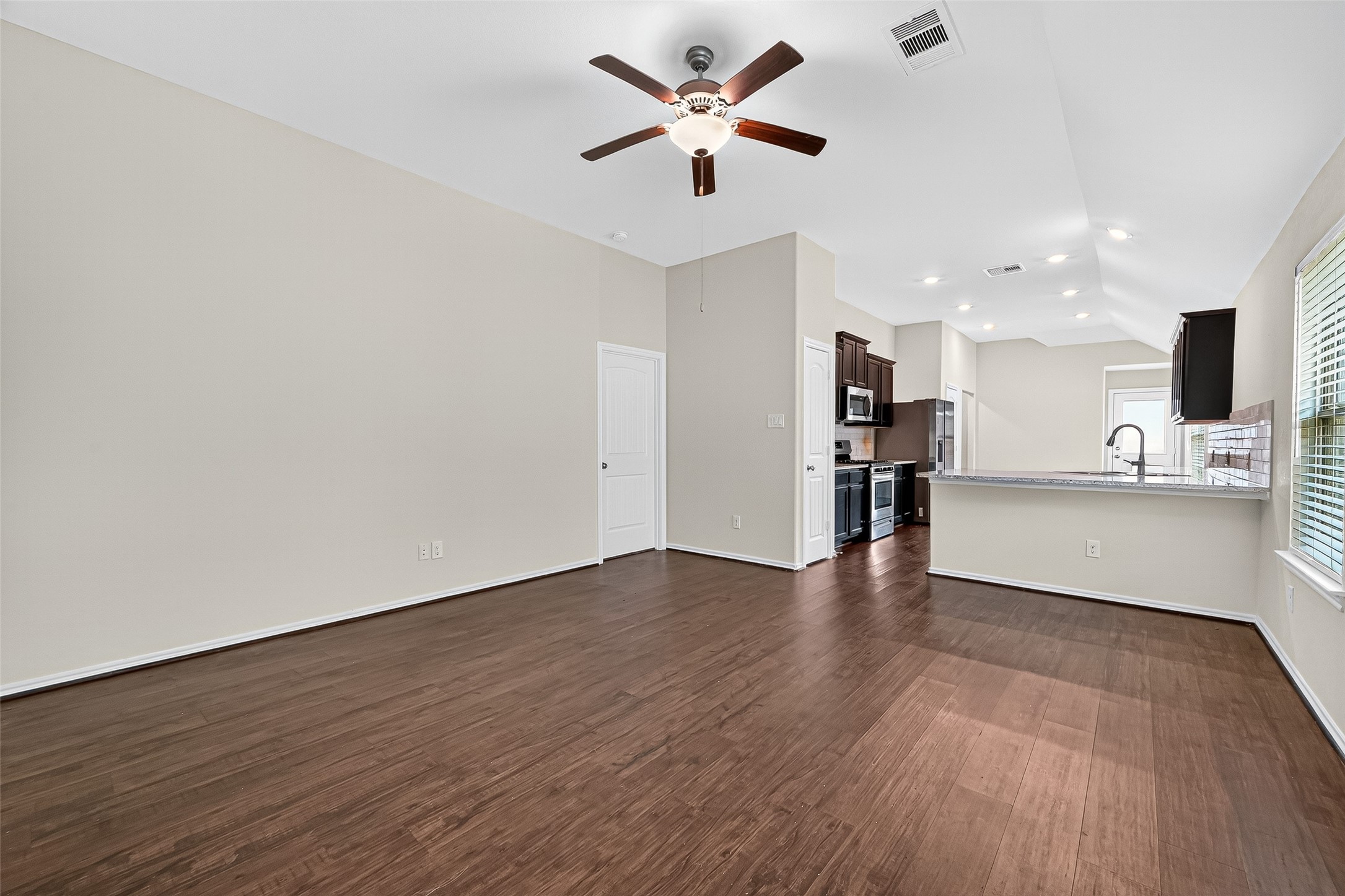 5603 Savanna Pasture Road Katy, TX 77493 - Photo 6 of 29 a view of kitchen with wooden floor and window