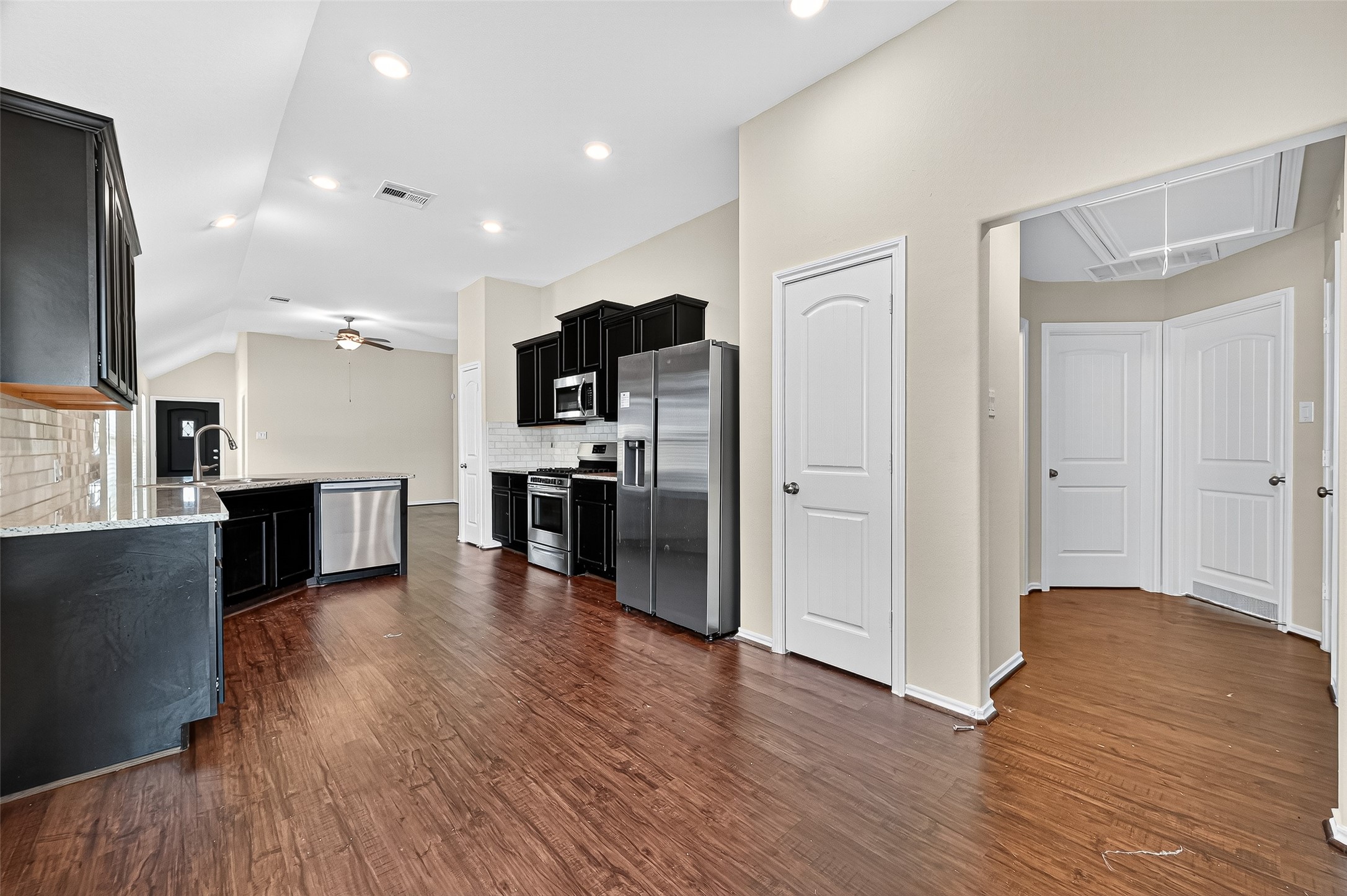 5603 Savanna Pasture Road Katy, TX 77493 - Photo 9 of 29 a kitchen with stainless steel appliances wooden floor and large windows