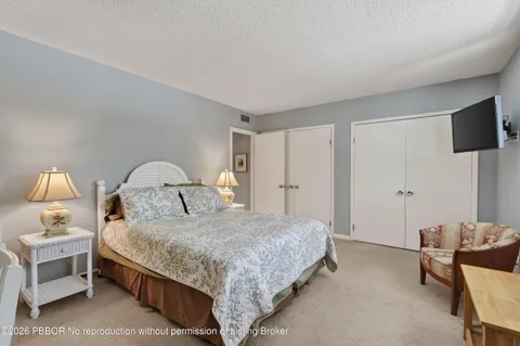 a bedroom with a bed and a lamp on table