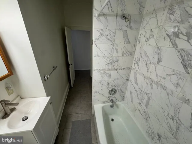 a bathroom with a sink and shower