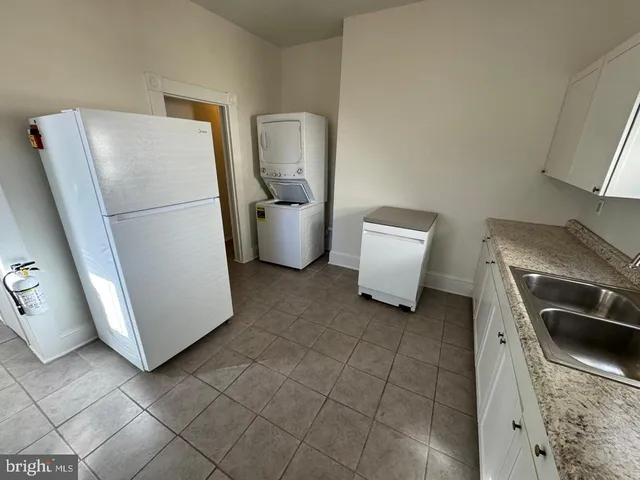 a kitchen with a refrigerator and a sink
