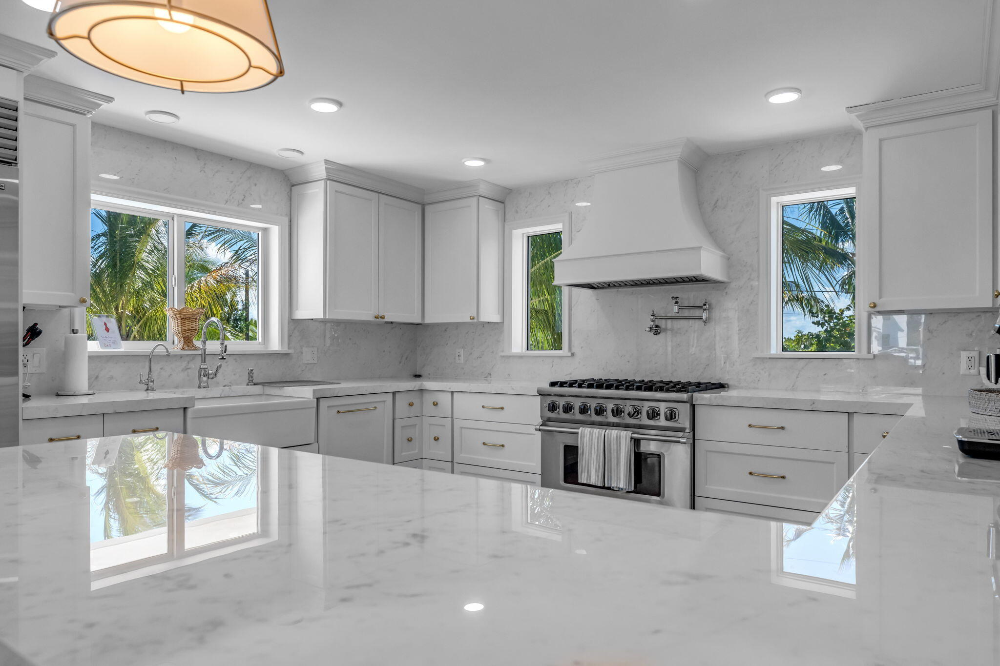 Undisclosed Address Key Largo, FL 33037 - Photo 13 of 56 a kitchen with stainless steel appliances granite countertop a stove a sink and a granite counter tops with white cabinets