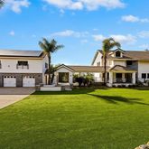 a front view of a house with garden and swimming pool