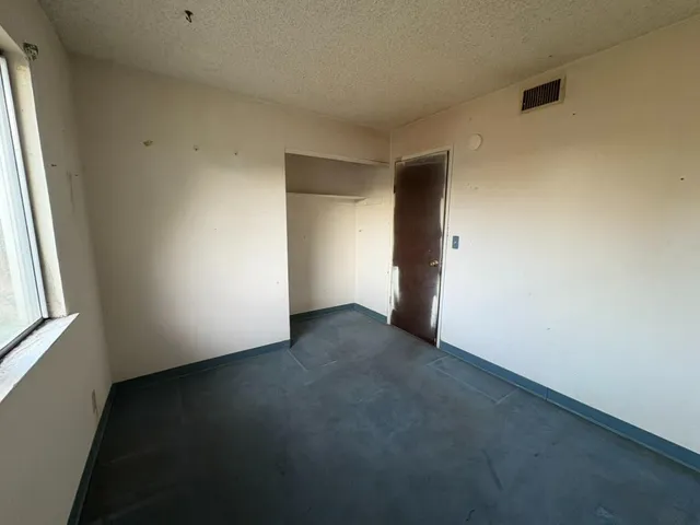 a view of an empty room with a window