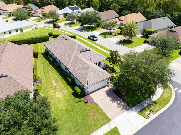 an aerial view of residential house with outdoor space pool patio and lake view