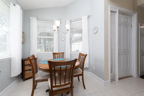 a view of a dining room with furniture and windows