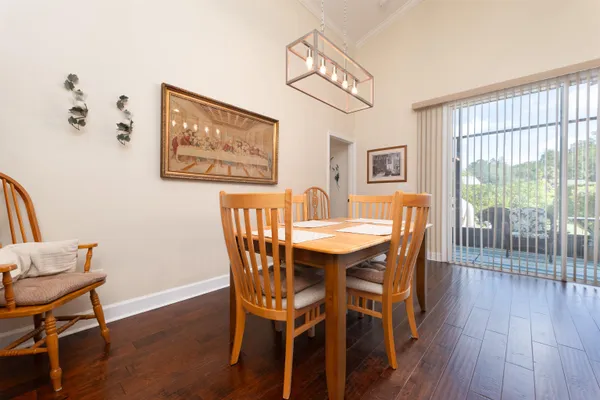 a view of a dining room with furniture and wooden floor