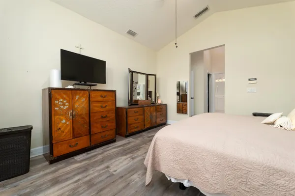 a bedroom with a bed and a flat screen tv