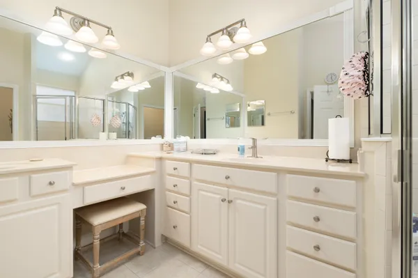 a bathroom with a sink vanity and a mirror