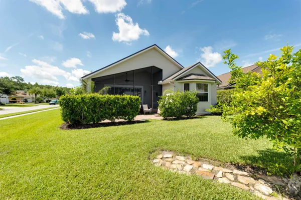 a view of a house with a garden and yard
