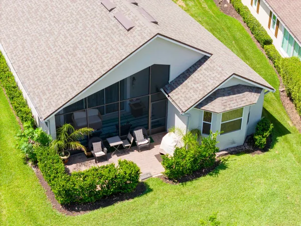 a front view of a house with porch and garden