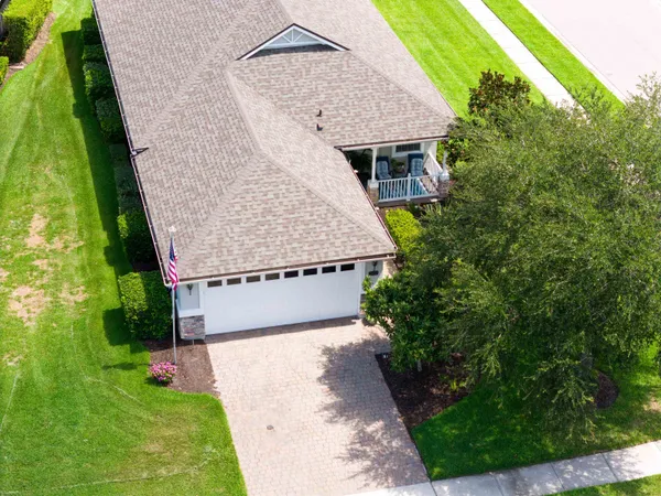 a aerial view of a house with a yard and potted plants