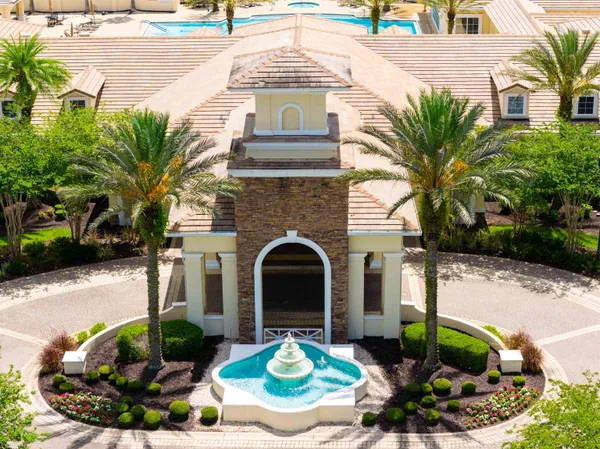 a view of a backyard with a patio and swimming pool